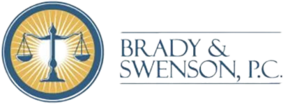 The logo for 'Brady & Swenson, P.C.', which is a legal firm. The logo features a stylized scale of justice in white, centered within a circular navy blue badge with a radiant gold border. The scale symbol is flanked by golden rays.